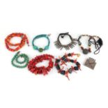 Middle Eastern jewellery including coral and stone necklaces and silver coloured metal bracelet :