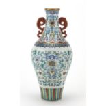 Chinese porcelain doucai vase with iron red handles, finely hand painted with flower heads amongst