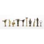 Ten antique pipe tampers including swan, figural, boot and hand design examples, the largest 6.5cm