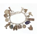 Silver charm bracelet with a selection of mostly silver charms including cancan dancers, ballet