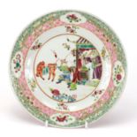 Chinese porcelain plate finely hand painted in the famille rose palette with figures within a