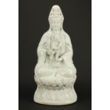 Large Chinese Blanc de Chine porcelain figure of Guanyin holding a young child, impressed