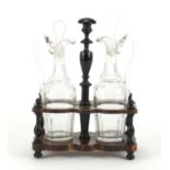 Pair of antique oil and vinegar decanters, housed in an ebonised stand, 28cm high : For Further