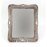 Rectangular silver easel mirror embossed with leaves and shells, indistinct hallmarks, RD number