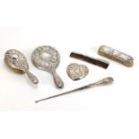 Six silver vanity items including hand mirror, brushes and heart shaped pin dish, various hallmarks,