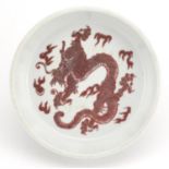 Chinese porcelain iron red dish, hand painted with a dragon chasing the flaming pearl amongst
