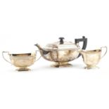 Silver three piece tea set, by John Taylor & Co, Birmingham 1938, the teapot 30cm in length,