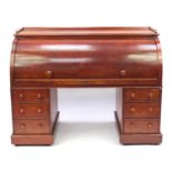 Mahogany twin pedestal cylinder bureau with fitted interior, pull out writing shelf and six drawers,