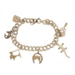 Silver charm bracelet with a selection of mostly silver charms including lighter, sewing machine and