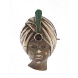 Silver and enamel brooch in the form of an Indian bust, set with a garnet, 3.5cm in length,