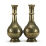 Pair of 19th century Persian bronze vases, engraved with script, animals and flowers, each 30cm high