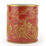 Chinese porcelain iron red brush pot, decorated in relief and gilded with qilins in a landscape,