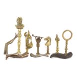 Ten antique pipe tampers including King George V, horse head and leg design examples, the largest