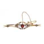 Art Nouveau 9ct gold seed pearl and garnet bar brooch, 6.5cm in length, approximate weight 3.9g,