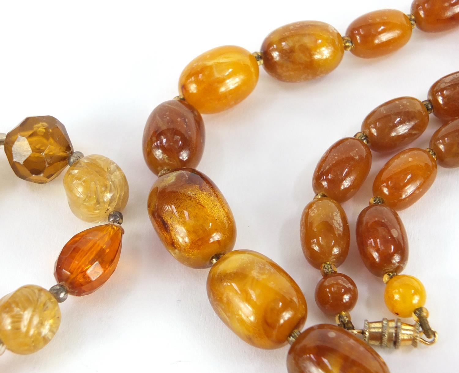 Three amber coloured bead necklaces and a bracelet, the largest 68cm in length, approximate weight - Image 5 of 6