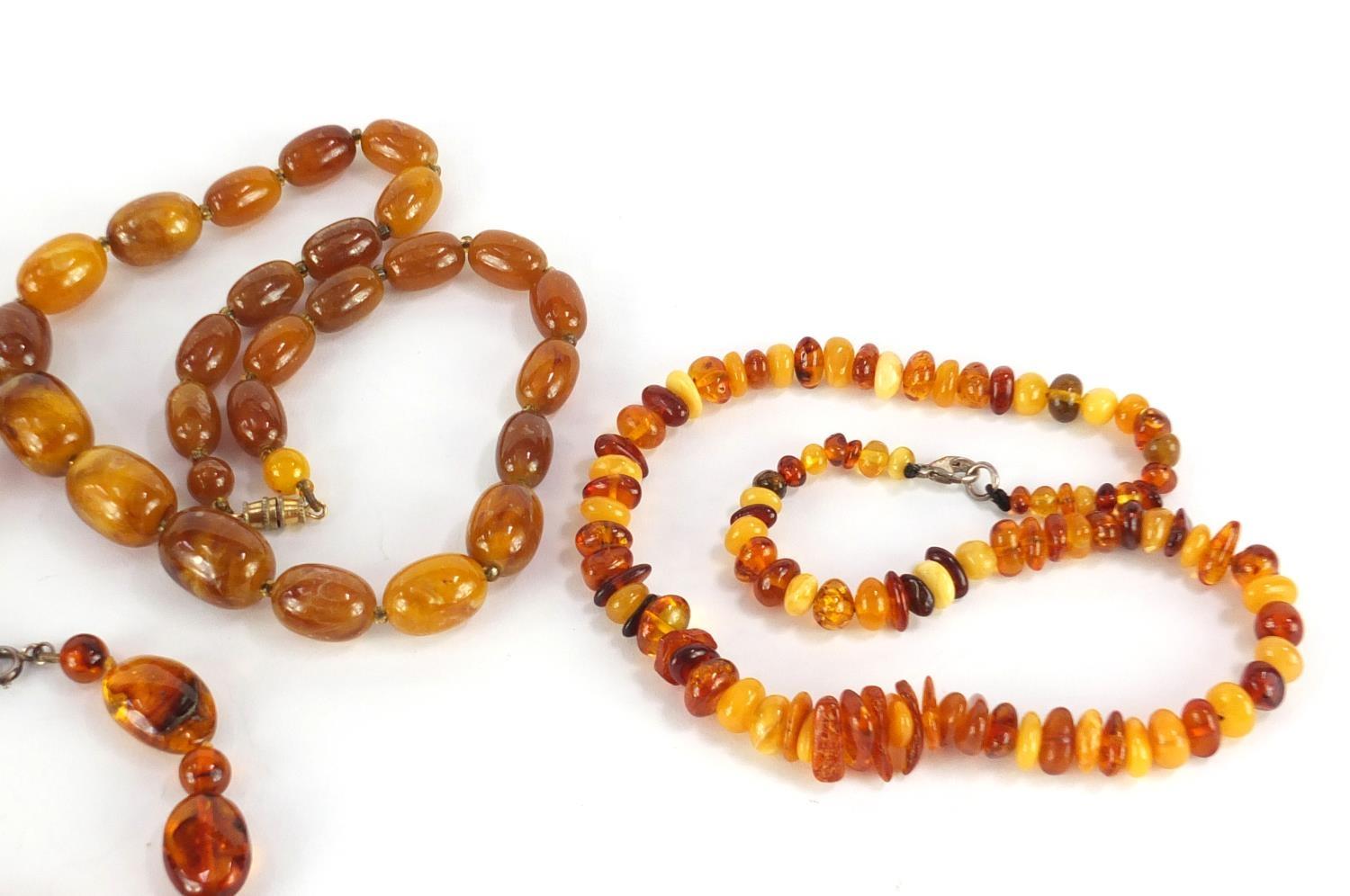 Three amber coloured bead necklaces and a bracelet, the largest 68cm in length, approximate weight - Image 3 of 6