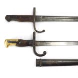 Two military interest bayonets including a French example with scabbard, various impressed marks,