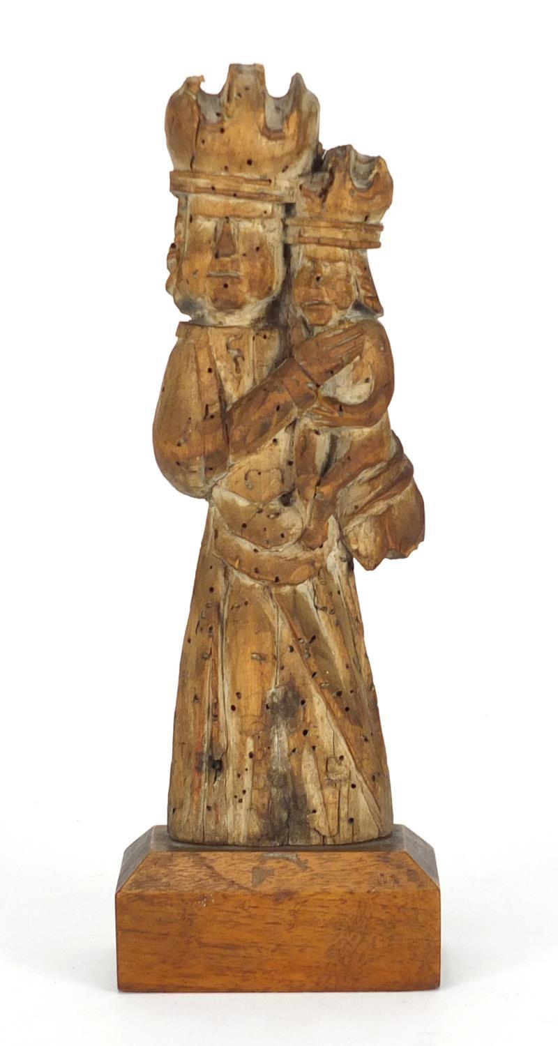 14th/15th century limewood carving of Madonna and child, raised on a rectangular mahogany block