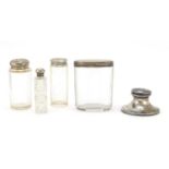 Four cut glass jars and bottles with silver lids and a silver inkwell, various hallmarks, the