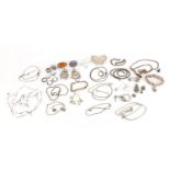 Silver and white metal jewellery including an amber brooch, filigree butterfly brooch, gate bracelet