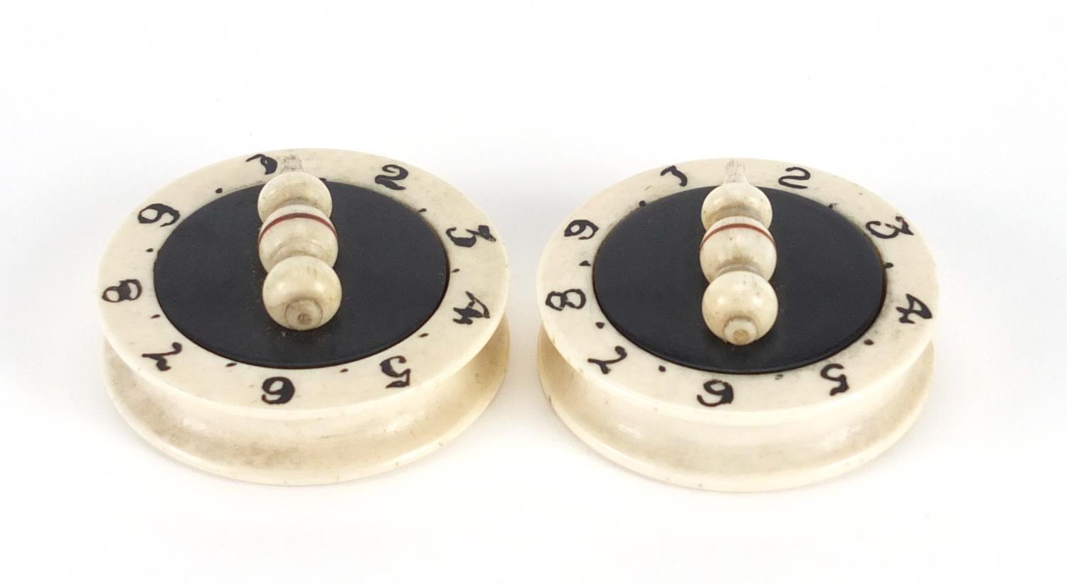 Pair of Victorian carved bone and ebony whist markers, each 4cm in diameter : For Further