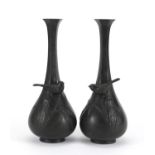 Pair of Japanese Meiji period patinated bronze vases, each cast in relief with a bird amongst