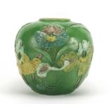 Chinese porcelain green glazed jar, decorated in relief with a craned amongst flowers and reeds,