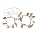 Silver charm bracelet with a selection of mostly silver charms including aeroplane, post box,