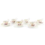 Set of six 19th century Berlin cups and saucers, each hand painted with flowers below a gilt border,