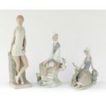 Three Lladro figurines comprising a tennis player and two girls seated with birds, the largest
