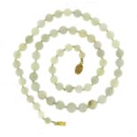 Chinese green jade bead necklace with unmarked silver gilt clasp, 68cm long, 85.5g :For Further