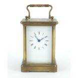 Brass cased carriage clock with enamelled dial and Roman numerals, 11cm high :For Further