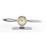 Military interest chrome eight day desk clock in the form of a propeller, impressed Regd no.
