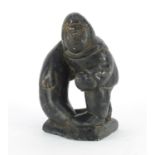 Inuit stone carving of a fisherman by Thomassie Tookalook, incised marks to the base, 12.5cm high :