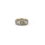 Unmarked gold and silver ring set with a central champagne diamond and two clear diamonds, size N,