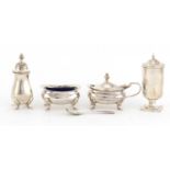Silver three piece cruet by Mappin & Webb and one other caster, the largest 8cm high, 152.5g :For