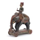 Indian lacquered push along figure on elephant back, hand painted with flowers, 38cm high :For