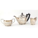 Silver demi fluted three piece tea service by Mappin & Web, Sheffield 1919, the teapot 25cm wide,