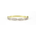 9ct gold crossover bangle set with clear stones, 6.8cm wide, 17.9g :For Further Condition Reports