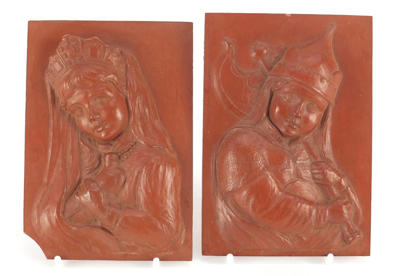 Pair of continental rectangular red clay plaques, finely decorated in relief with a young boy and