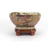 Japanese Satsuma bowl with hardwood stand, with figures and birds of paradise, 18cm square :For