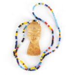 African tribal interest carved ivory pendant on bead necklace, the pendant 7cm high :For Further