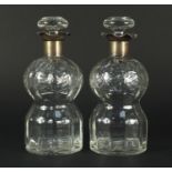 Pair of cut glass decanters with silver collars, both etched with flowers, each 22cm high :For