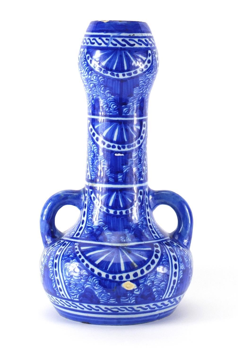 Islamic pottery vase with twin handles, hand painted with stylised flowers, 32cm high :For Further