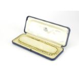 9ct gold pearl necklace, housed in a Kemp Brothers tooled leather box, 44cm in length, 22.8g :For