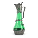 Art Nouveau pewter and green glass claret jug by Osiris, embossed with grapes on vines, impressed