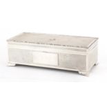 Good quality rectangular silver cigar box with engine turned decoration and lion crest, by Harman