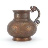 Good Persian copper jug with dragon handle, the body finely engraved with panels of calligraphy