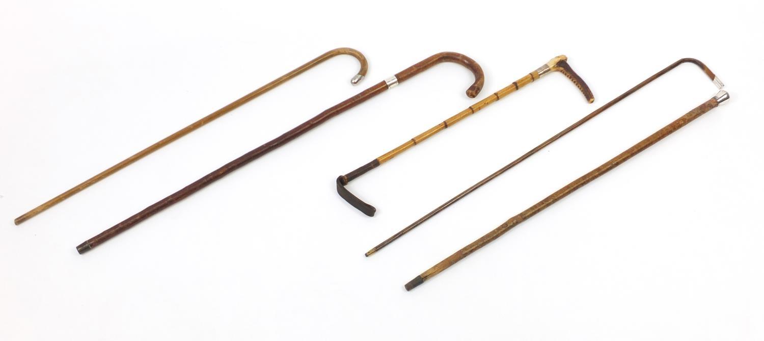 Four walking sticks with silver mounts and a Swain and Co silver mounted riding crop, the largest - Image 2 of 10