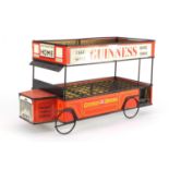 Vintage Guinness tin plate shop display bottle stand in the form of a bus, 47cm long :For Further